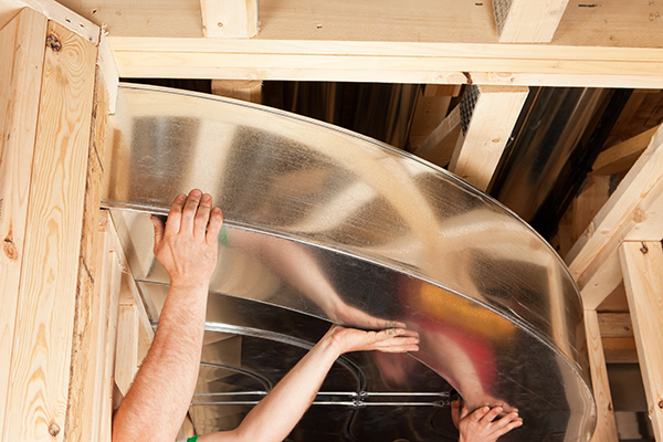 Workers Installing Complex HVAC Galvanized Duct Sections