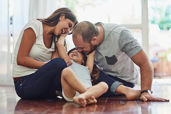 family on floor enjoying AC